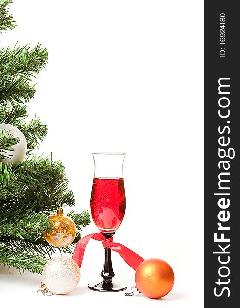 Christmas fur-tree with a glass of wine and an ornament on a white background for a card. Christmas fur-tree with a glass of wine and an ornament on a white background for a card