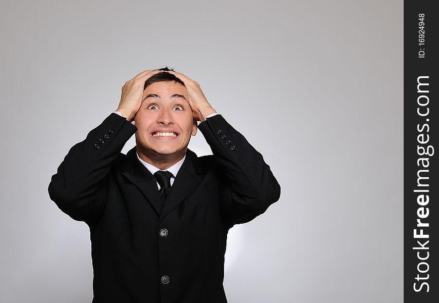 Expressions.Young handsome business man screaming of joy and luck. studio shot. Expressions.Young handsome business man screaming of joy and luck. studio shot