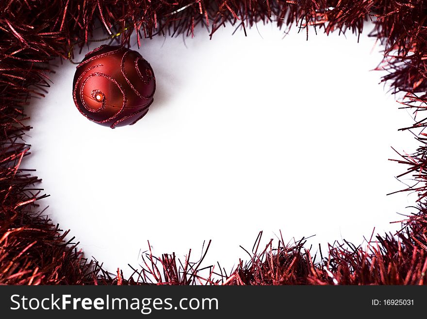 A Christmas red ball with red garland and white isolated center. A Christmas red ball with red garland and white isolated center
