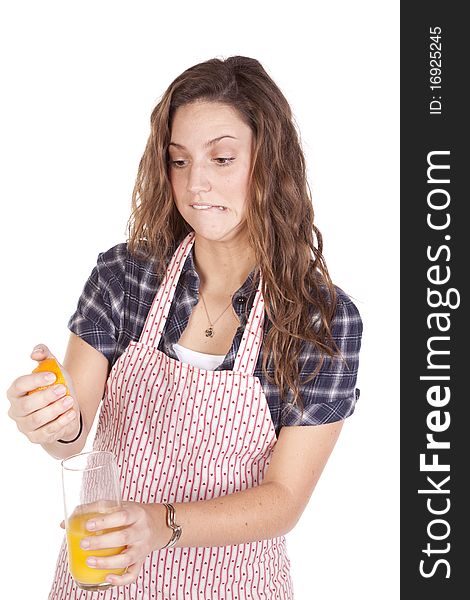 Woman squeezing orange juice hard