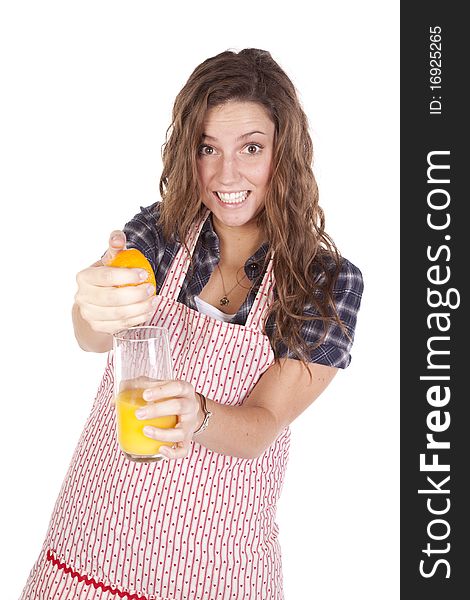 A woman is squeezing orange juice into a glass. A woman is squeezing orange juice into a glass.