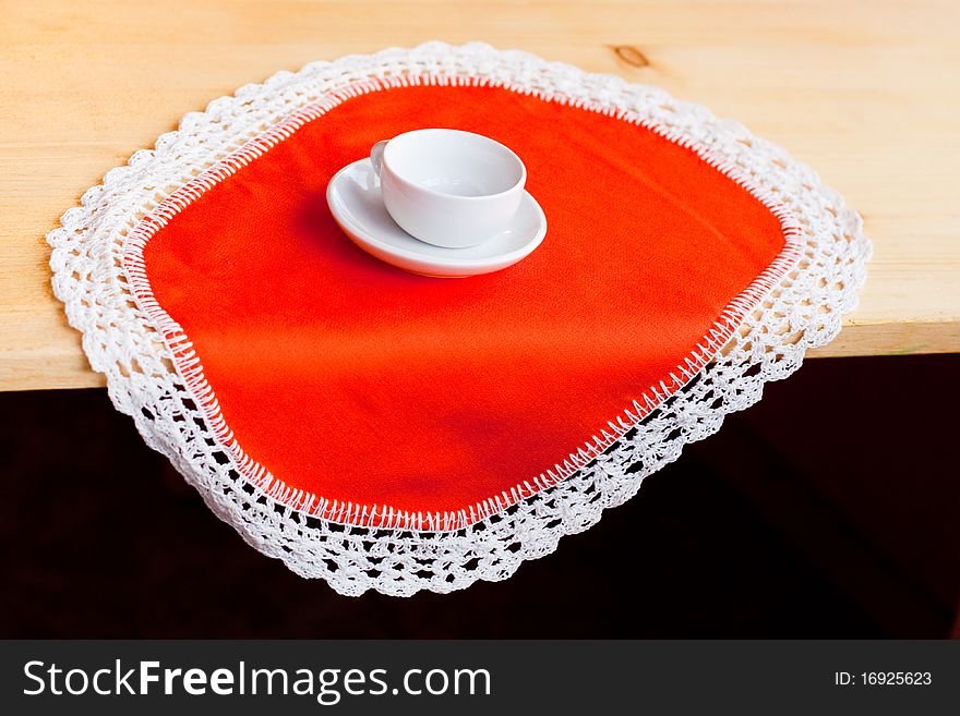 A coffee cup on an orange napkin