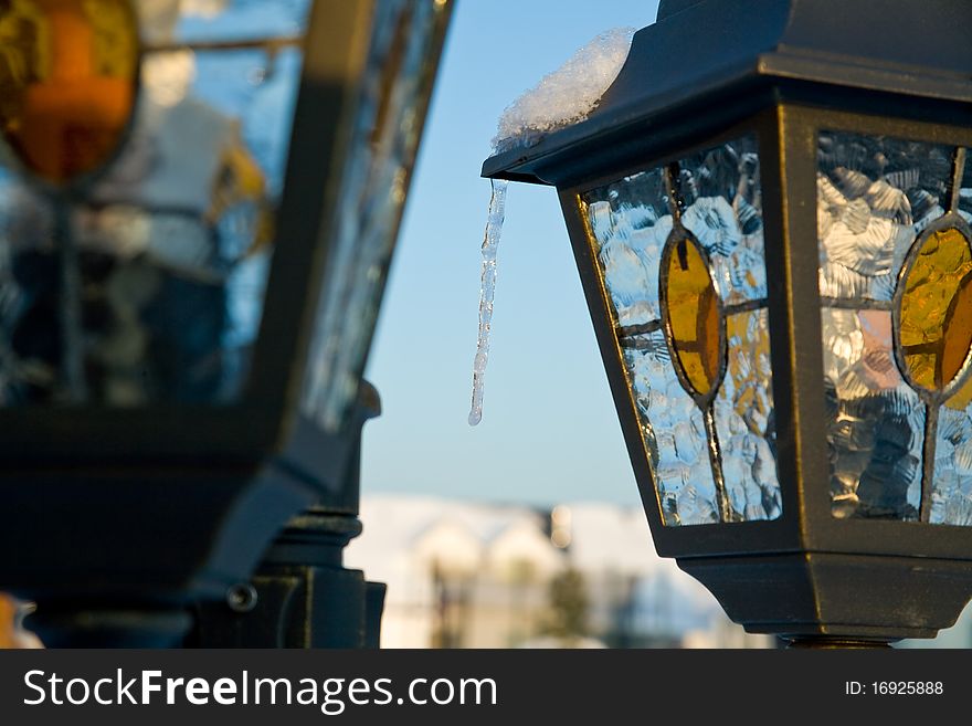 Icicle on the metal top of street lamp. Icicle on the metal top of street lamp