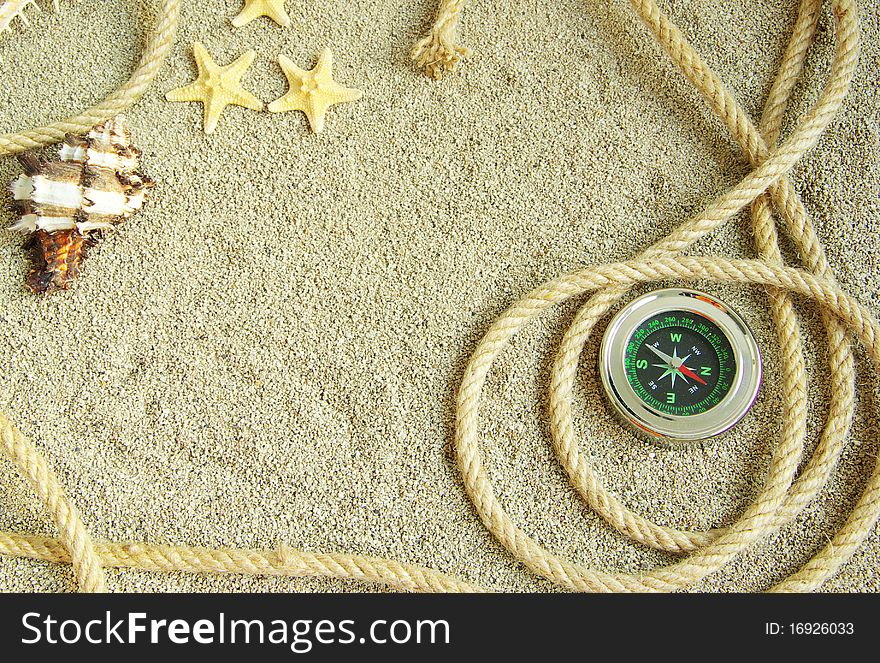 Starfish and shells in rope on sand