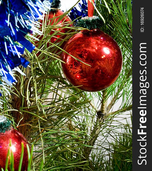 Red glass balls and tinsel on Christmas-tree. Red glass balls and tinsel on Christmas-tree