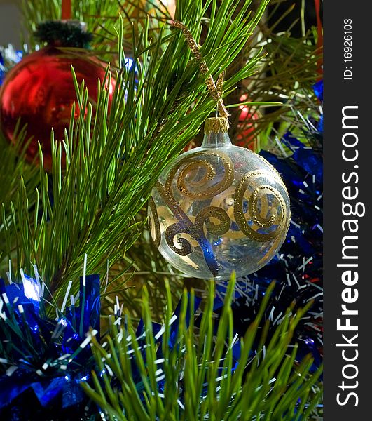 Two glass balls and tinsel on Christmas-tree. Two glass balls and tinsel on Christmas-tree