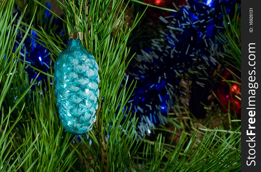 Blue glass cone and tinsel on Christmas-tree. Blue glass cone and tinsel on Christmas-tree