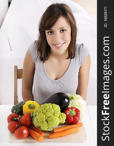 Young woman with raw vegetable smiling and looking in camera. Young woman with raw vegetable smiling and looking in camera