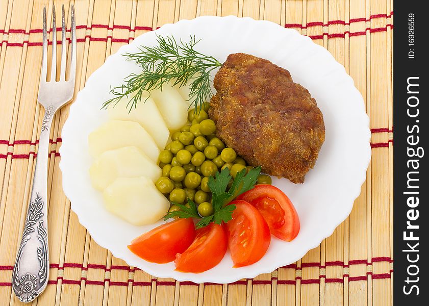 Close-up meat rissole with vegetables, isolated on white