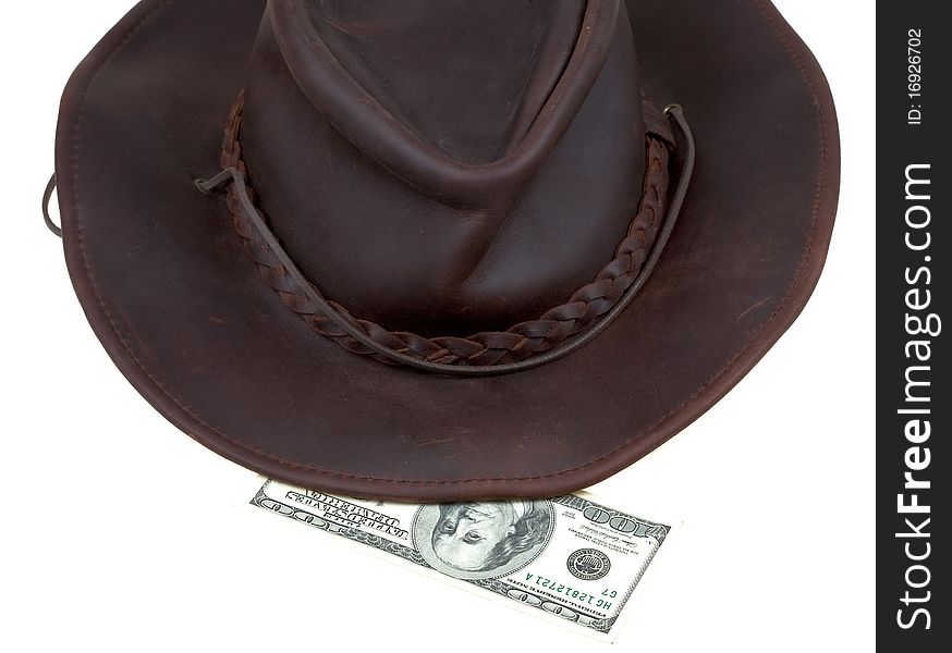 Leather brown cowboy hat with 100 dollars banknote isolated on white. Leather brown cowboy hat with 100 dollars banknote isolated on white