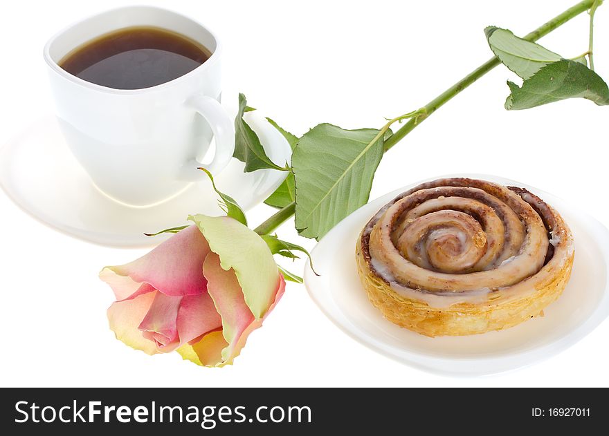 Close-up cake with cinnamon, tea and rose, isolated on white