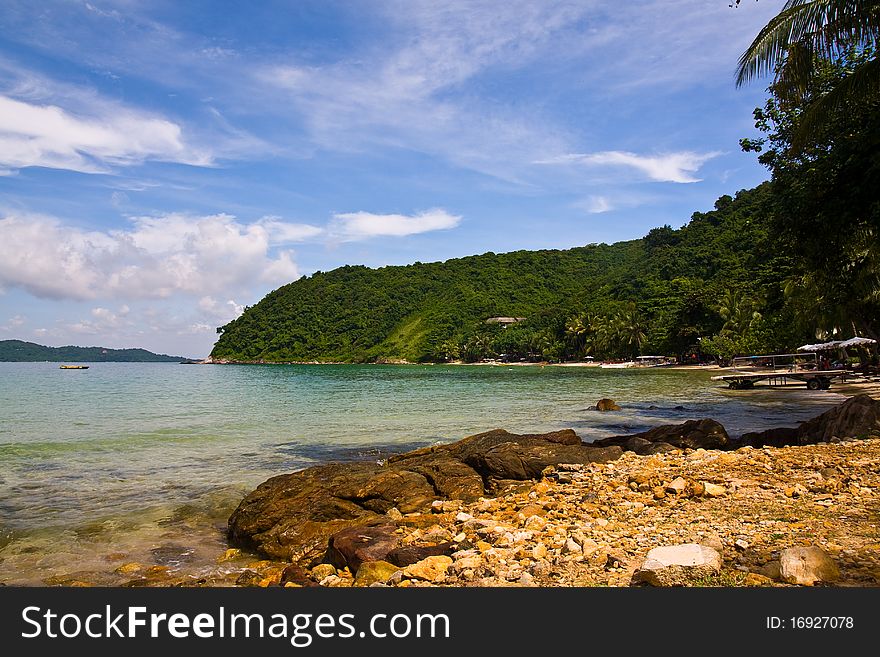 Beautiful beach with many rocks green water and blue sky. Beautiful beach with many rocks green water and blue sky