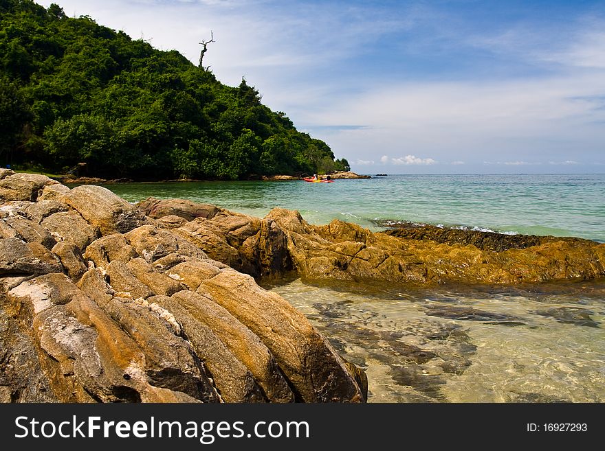 Sea with rock in foreground and island on far. Sea with rock in foreground and island on far