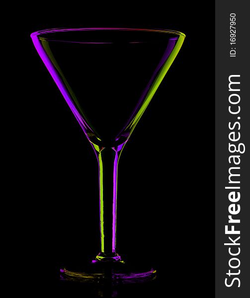 Transparent colored empty martini glass, isolated on black. Transparent colored empty martini glass, isolated on black