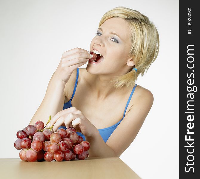 Portrait of young woman with grape