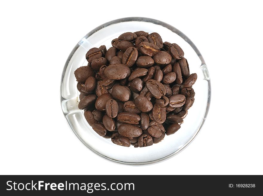Coffee beans lying over the glass dish