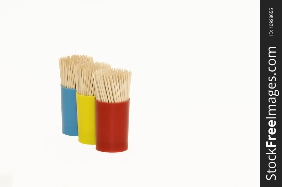 Three tubes with toothpicks on a white background