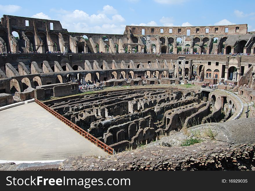 An interior view of the ruins of the ancient colosseum in the heart of Rome. An interior view of the ruins of the ancient colosseum in the heart of Rome