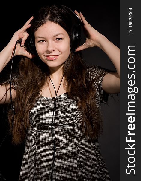 Young beauty girl in headphones listening music