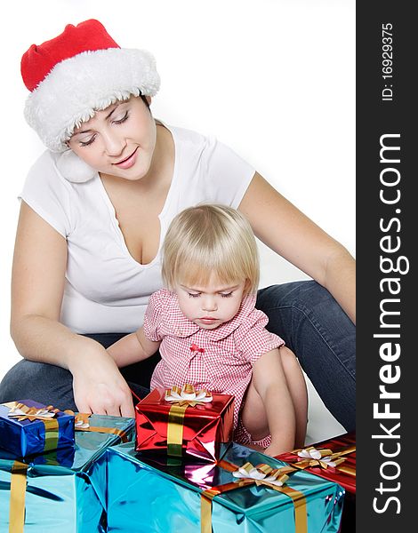 Mother and daughter with christmas gift boxes over white