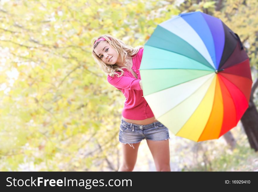 Happy young girl with colorful umbrella on natural background. Happy young girl with colorful umbrella on natural background