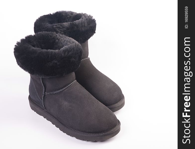 Winter fur boots over white background