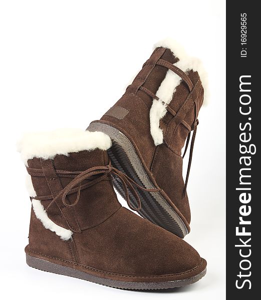 Fluffy woolly warm boots over white background