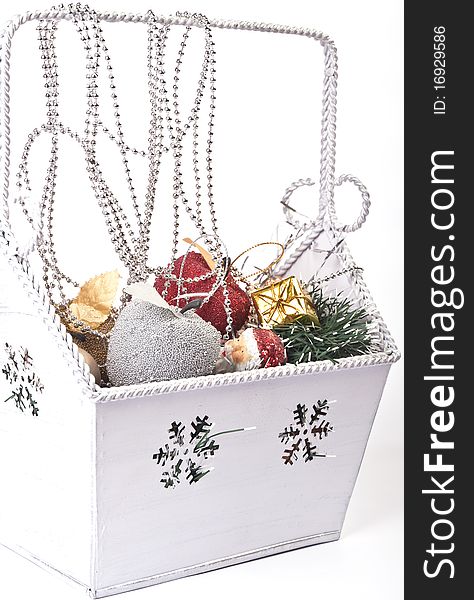 Box with christmas ornaments over white background