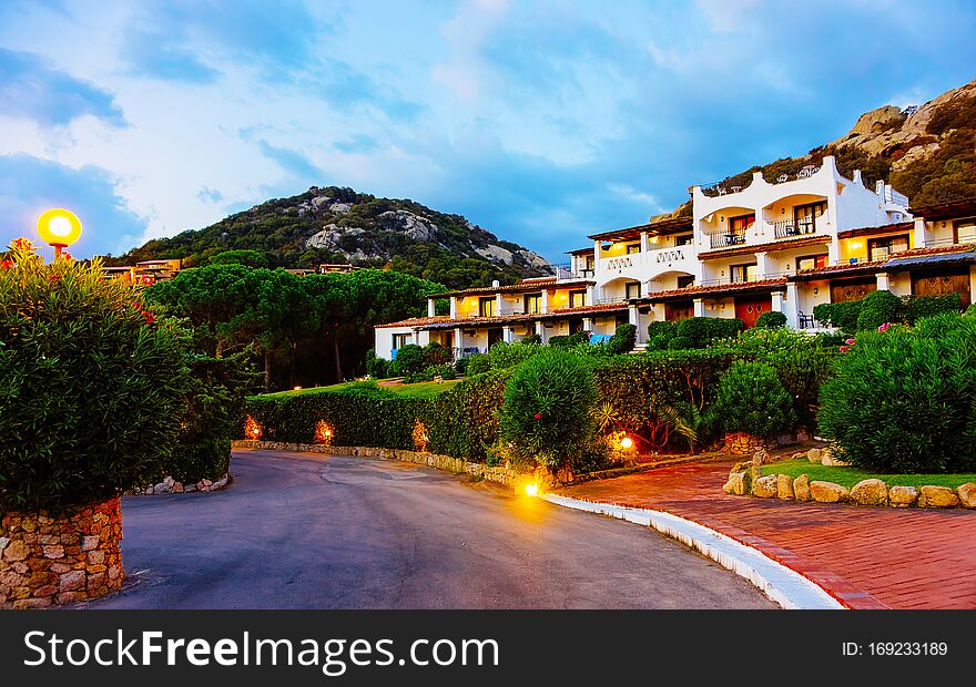 Houses at Baja Sardinia luxury resort at night on Sardinia reflex