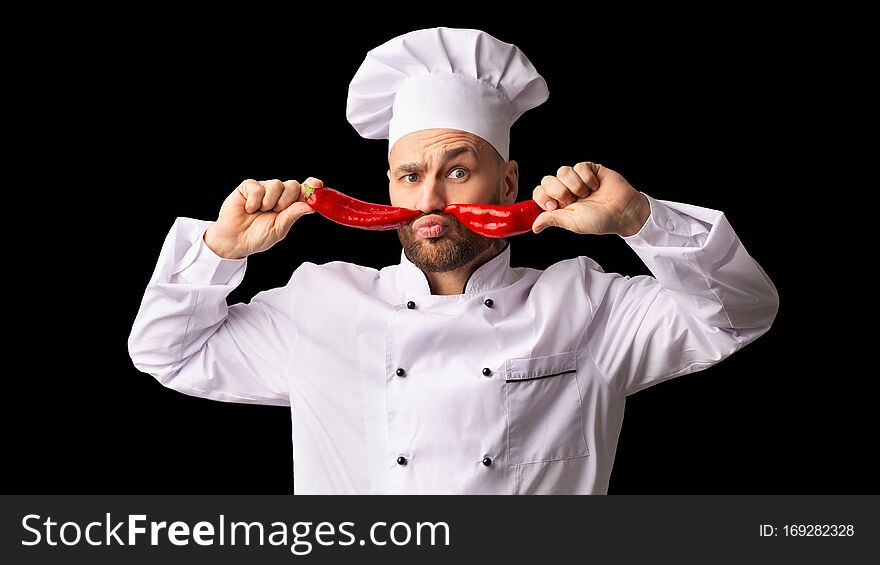 Chef Man Holding Red Peppers Like Moustaches, Black Background, Panorama