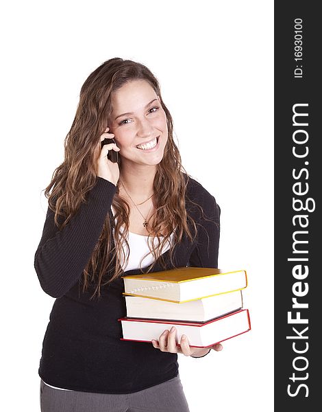 A business woman is holding books and talking on the phone. A business woman is holding books and talking on the phone.