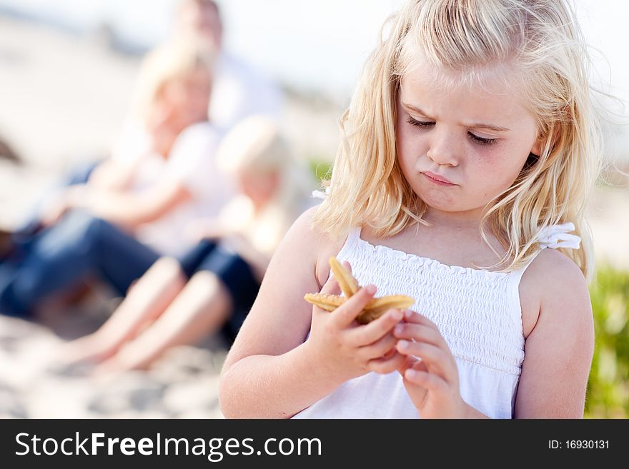 Adorable Little Blonde Girl With Starfish