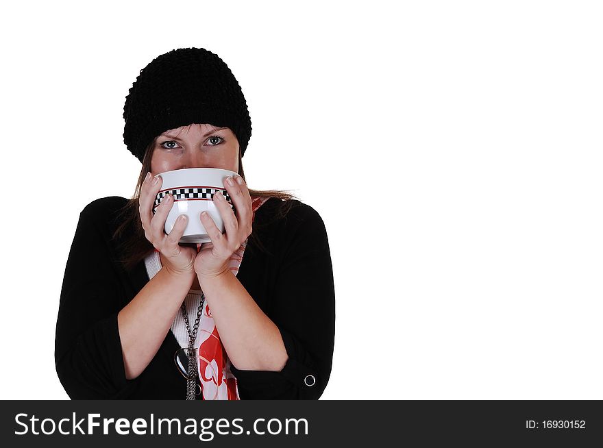 A middle aged woman drinking from a big cup some hot tea, with a sweater,scarf and hat on, with copy space on white background. A middle aged woman drinking from a big cup some hot tea, with a sweater,scarf and hat on, with copy space on white background.