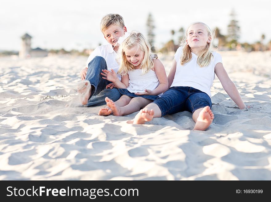 Young Sisters And Brother Having Fun At The Bea