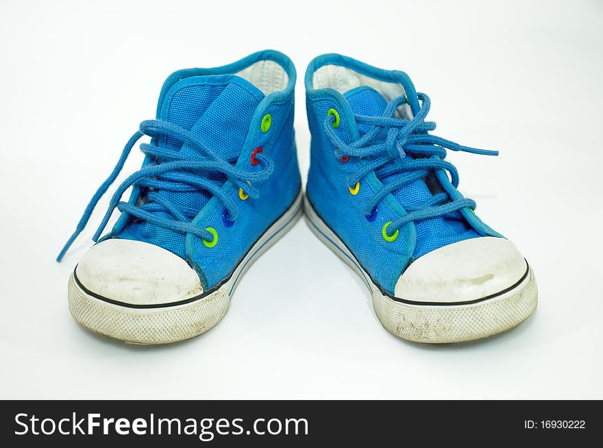 Closeup detail side a pair of old, dirty blue sneakers. Closeup detail side a pair of old, dirty blue sneakers