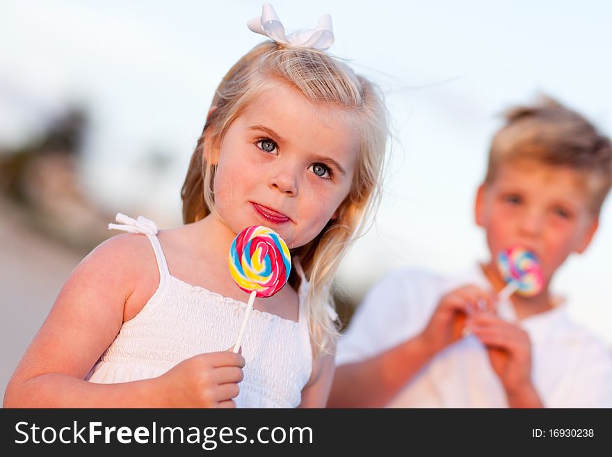 Cute Girl and Brother Enjoying Their Lollipops