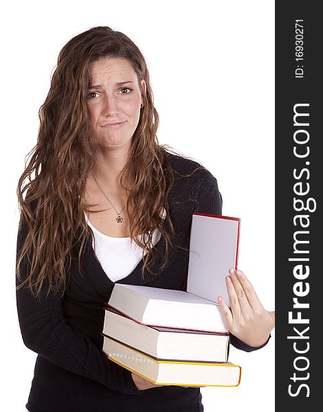 A woman is holding a stack of books and looks frustrated. A woman is holding a stack of books and looks frustrated.