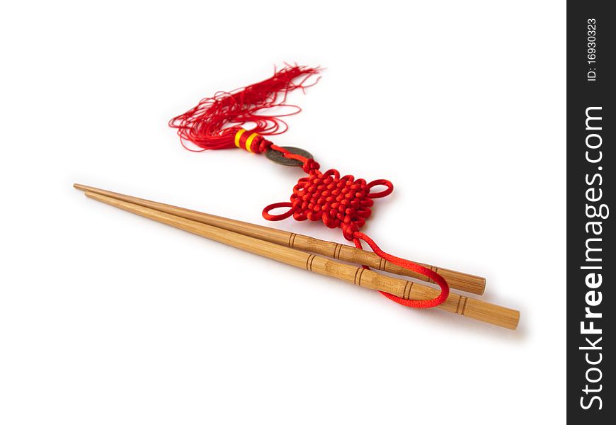 Chopsticks and red oriental decoration isolated on white