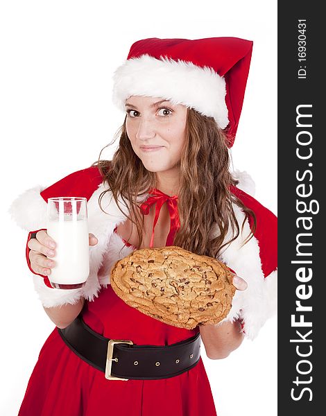 Mrs Santa is holding a big cookie and a glass of milk. Mrs Santa is holding a big cookie and a glass of milk.