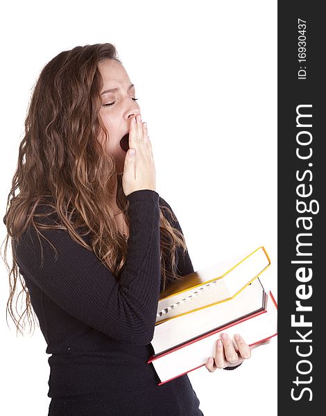 A woman is holding a stack of books and yawning. A woman is holding a stack of books and yawning.
