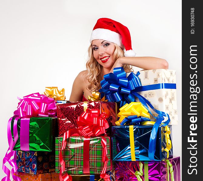 Beautiful blond girl in christmas costume with gifts