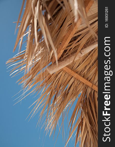 Part of beach umbrella made of dried leaves