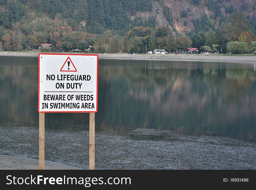 No lifeguard sign with nature view of Harrison Hot Springs