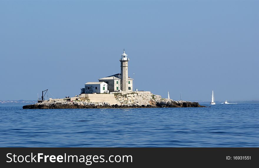 Lighthouse in the sea on a clear cloudless weather