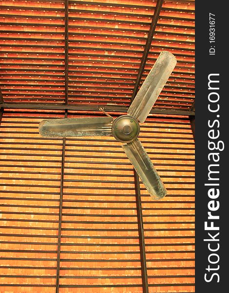 Classical ceiling fan with a background of orange baked clay tiles in Thailand