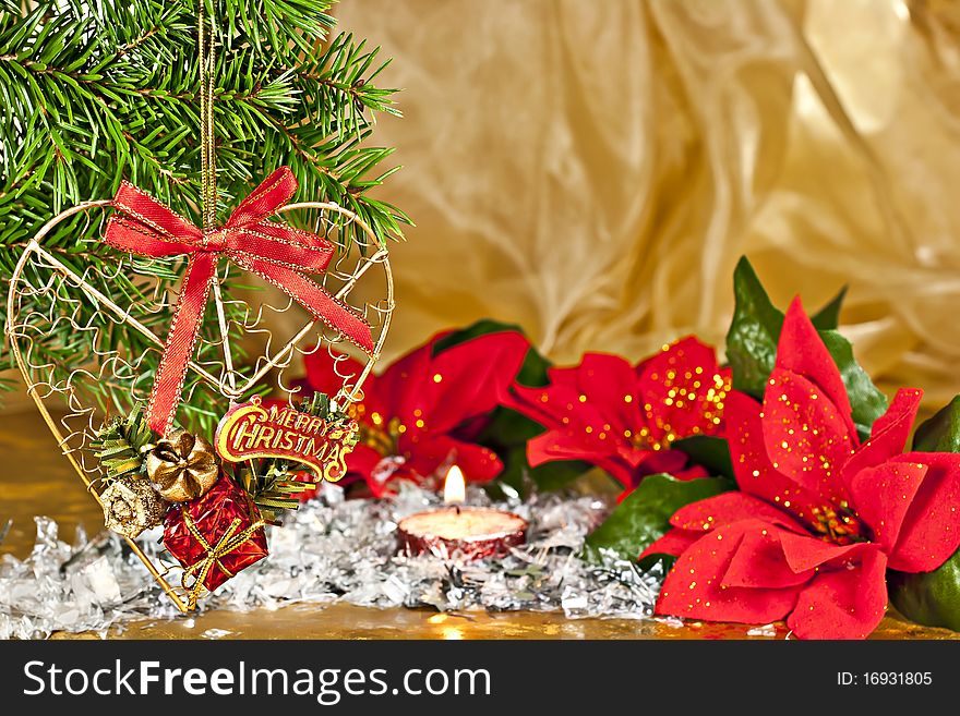 Christmas composition, fir branch with the decor, Poinsettia on gold background. Christmas composition, fir branch with the decor, Poinsettia on gold background.