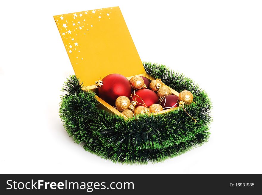 Golden box with christmas balls isolated on white background. Golden box with christmas balls isolated on white background