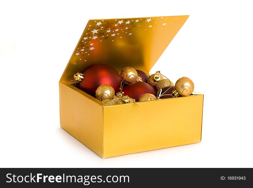 Golden box with christmas balls isolated on white background. Golden box with christmas balls isolated on white background