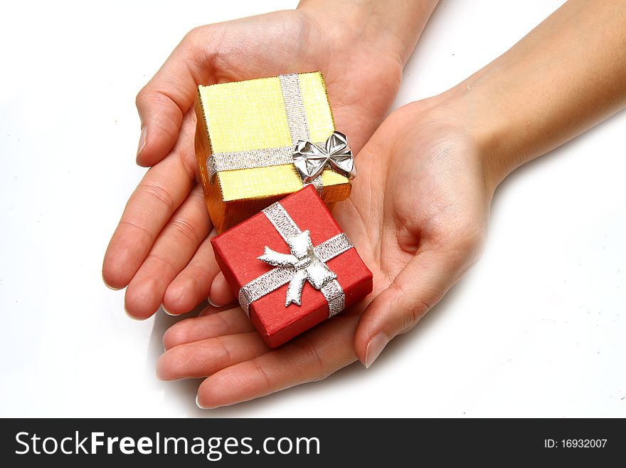 A Woman is holding a gift. A Woman is holding a gift