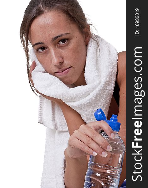 Sports Woman resting with towel over her neck and drinking water